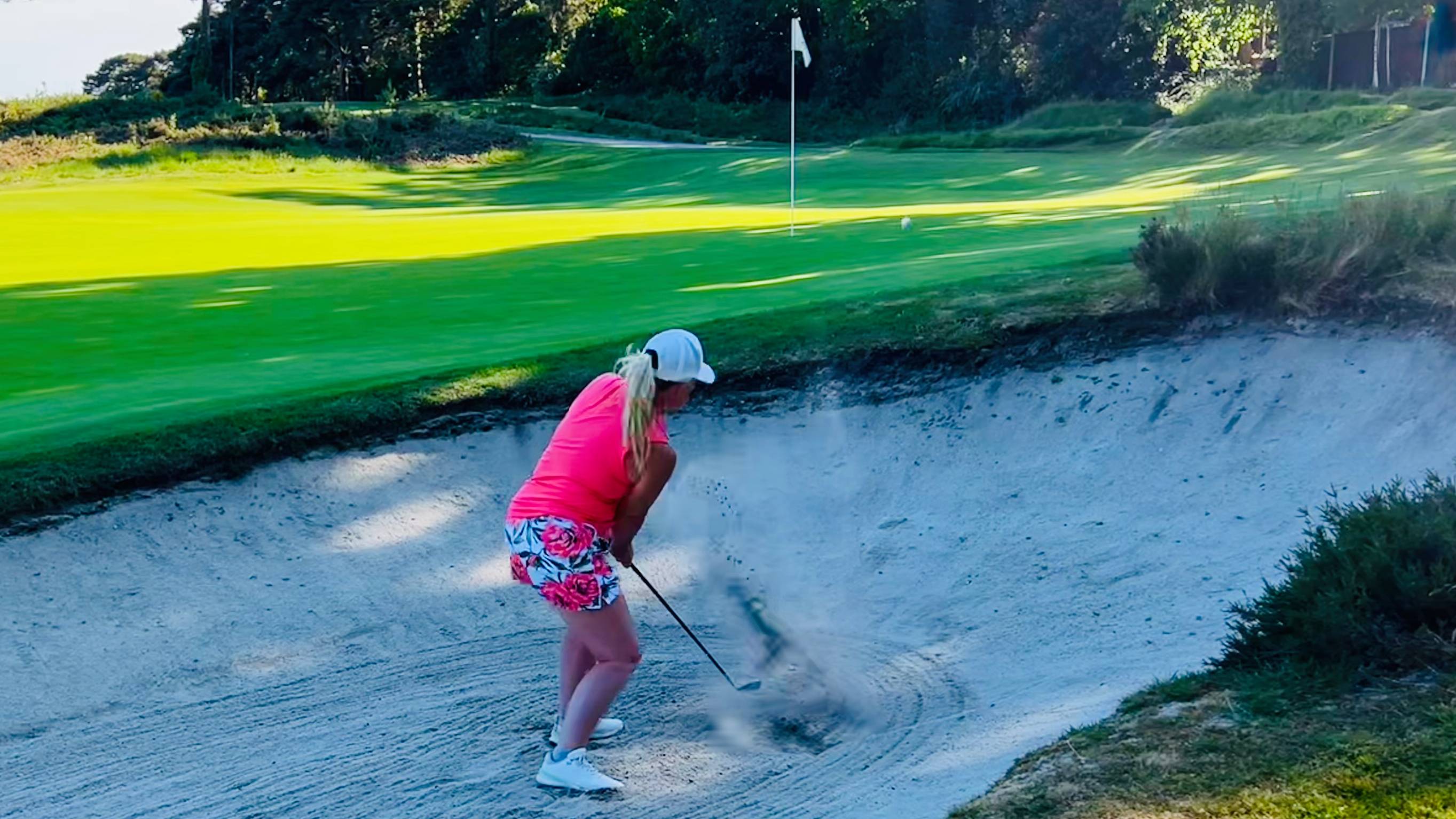 Carly Cummins hitting a bunker shot with a 7-iron