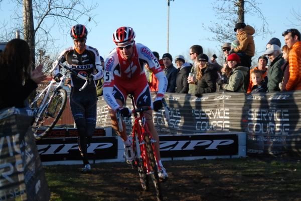 Todd Wells leads Geoff Kabush over the barriers.