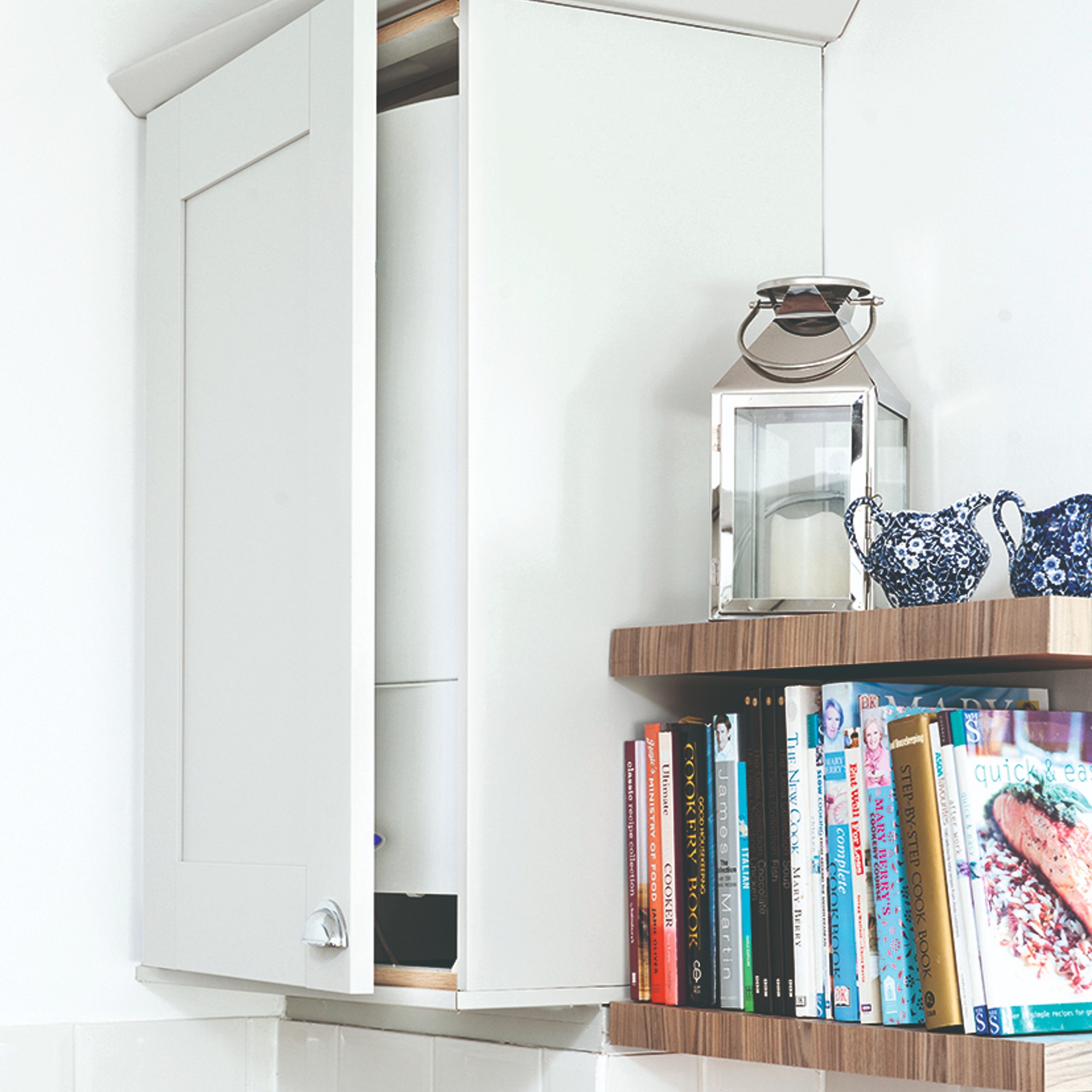 A kitchen with a boiler cupboard and bookshelves