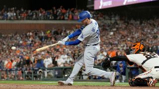 Cody Bellinger #35 of the Los Angeles Dodgers hits an RBI single to score Justin Turner #10 against the San Francisco Giants during the ninth inning in game 5 of the National League Division Series at Oracle Park on Oct. 14, 2021 in San Francisco, California.