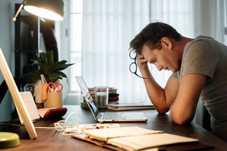 Man stressed in home office
