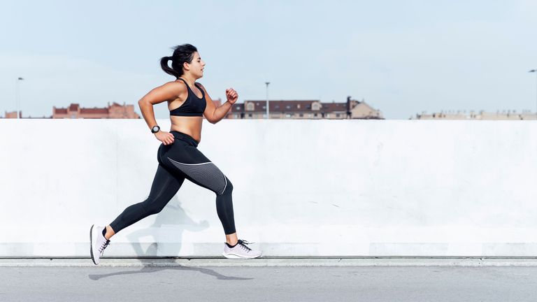 Young woman running training in the city