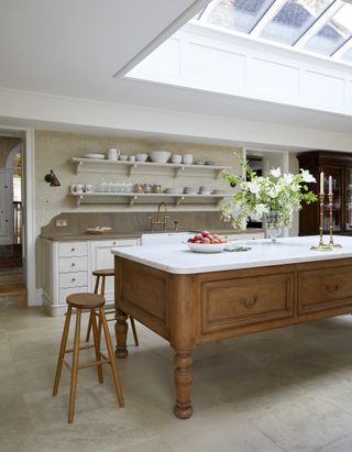 wooden table style kitchen island with marble work top