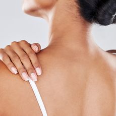 woman massaging her shoulder from chronic pain