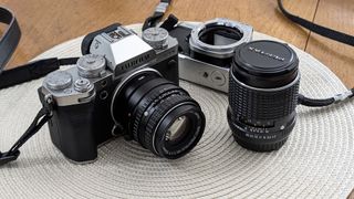 Fujifilm X-T5 with lens next to camera lens