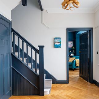 hallway with blue painted staircase