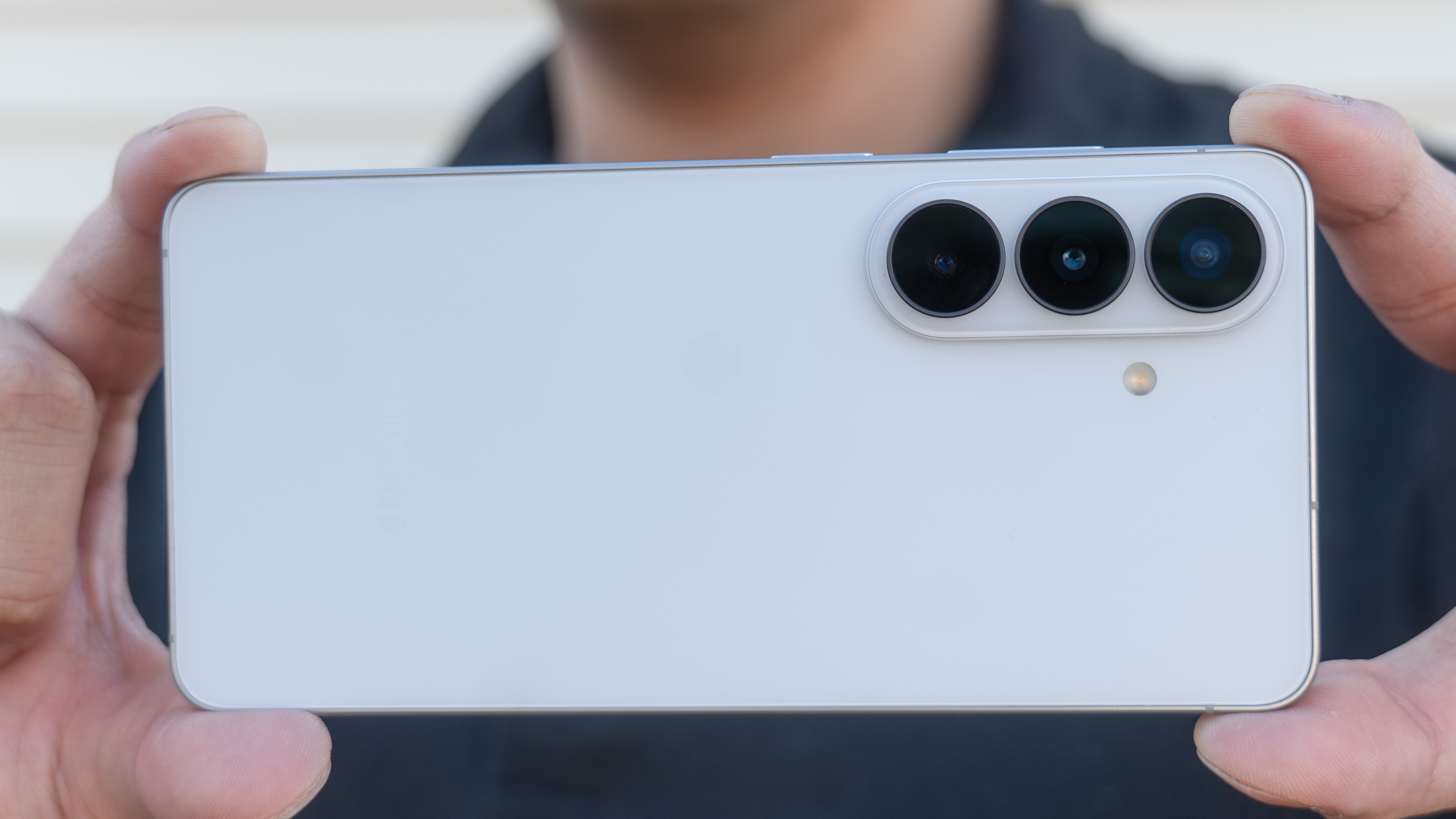 Samsung Galaxy S26 held in the hand to take a photo.