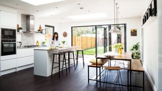 Cheap extension ideas: white light-filled kitchen extension with industrial style seating and dining table