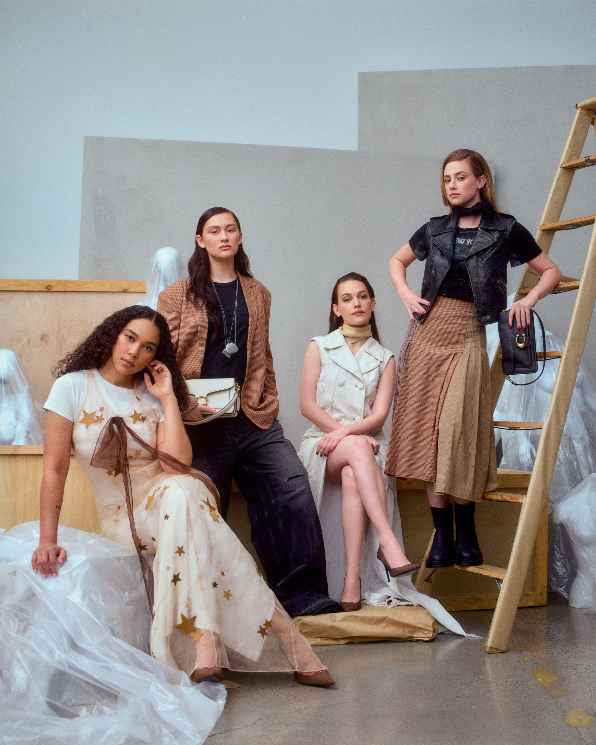 Forbidden Fruits actors for the Who What Wear 2026 Spring Issue posing in front of a cream wall sitting in various spots wearing dresses and jackets in creams and browns.