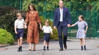 Prince George, Princess Charlotte and Prince Louis (C), accompanied by their parents the Prince William, Duke of Cambridge and Catherine, Duchess of Cambridge, arrive for a settling in afternoon at Lambrook School