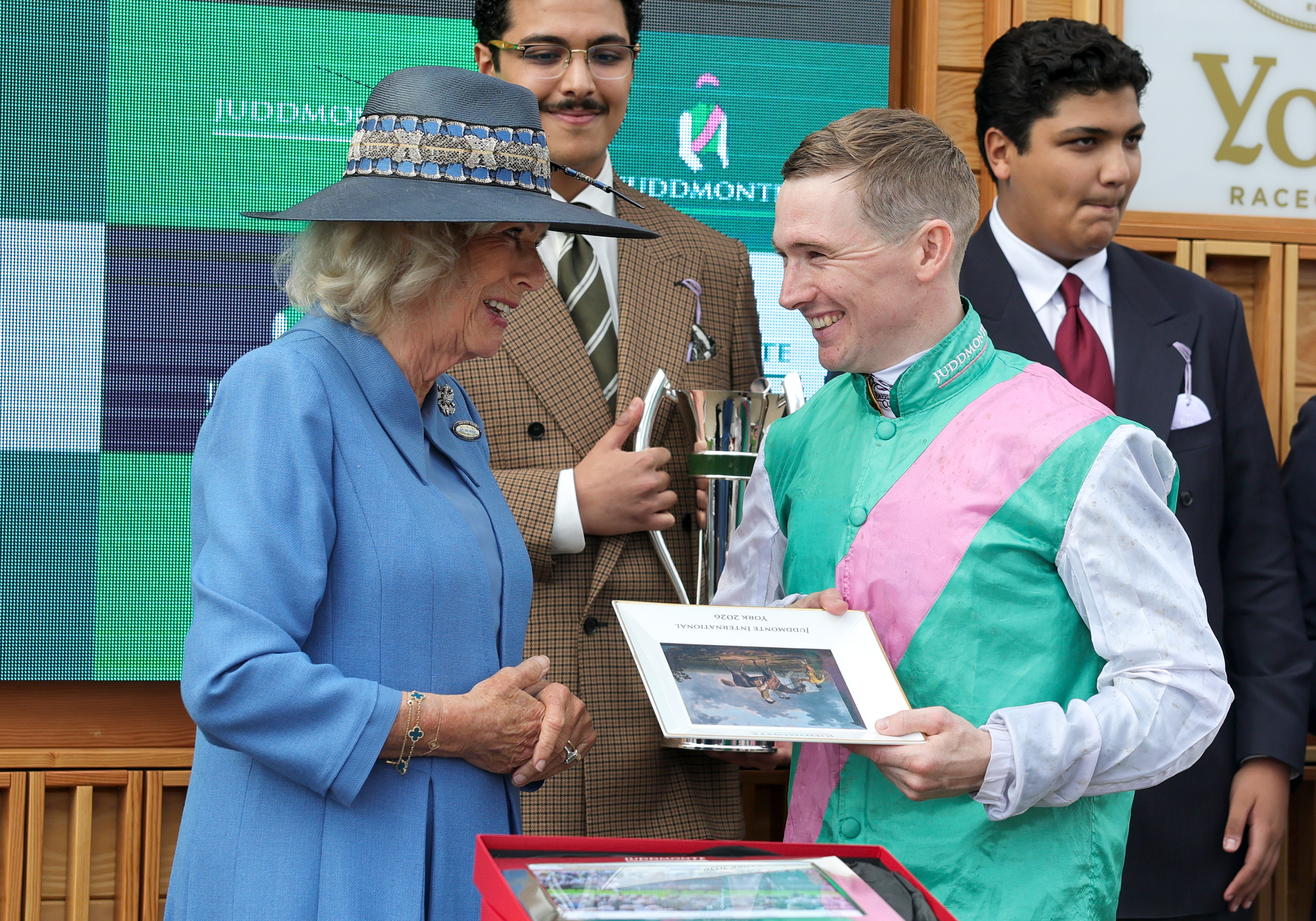 Queen Camilla speaking with a horse jockey