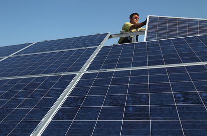 Worker installing solar panels.