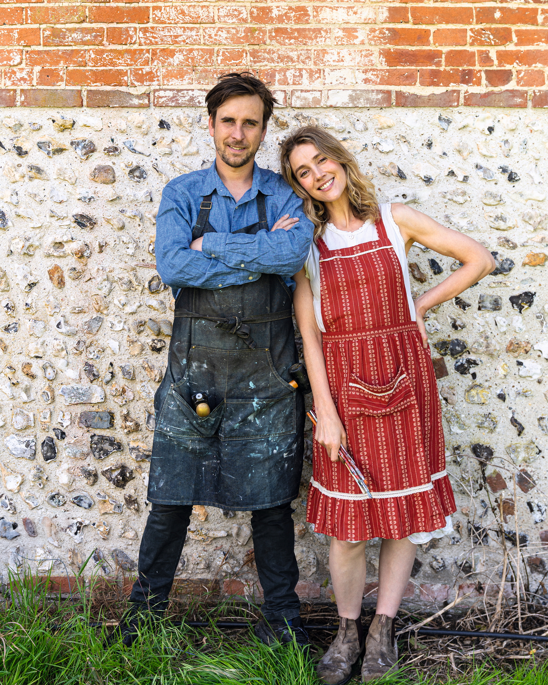Alfred and Tess Newall standing by a brick wall