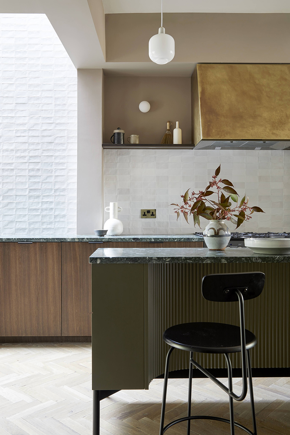 kitchen with pale walls and green island