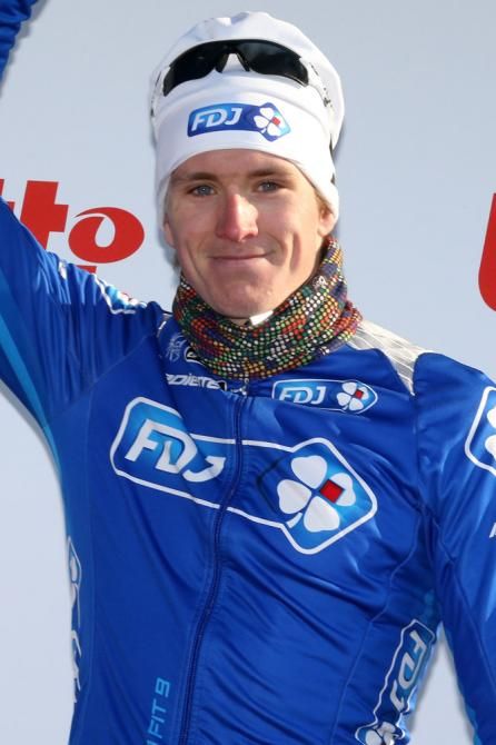 Arnaud Demare (FDJ) salutes the crowd as steps on stage to receive the leader's jersey.