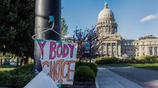 A sign taped to a hanger hangs near the Idaho Capitol in Boise after protests against the state's new abortion laws