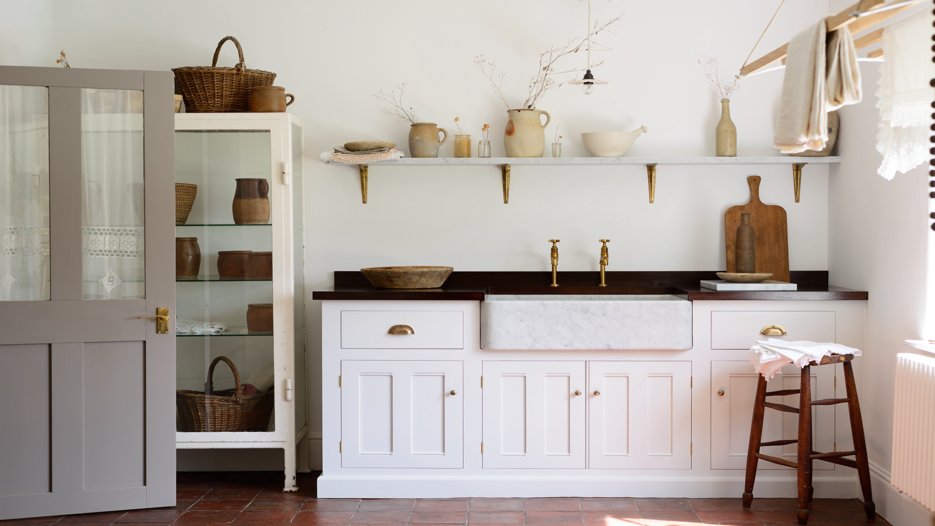 A Shaker style utility room showing open shelving storage, Belfast sink and a ceiling clothes airer 