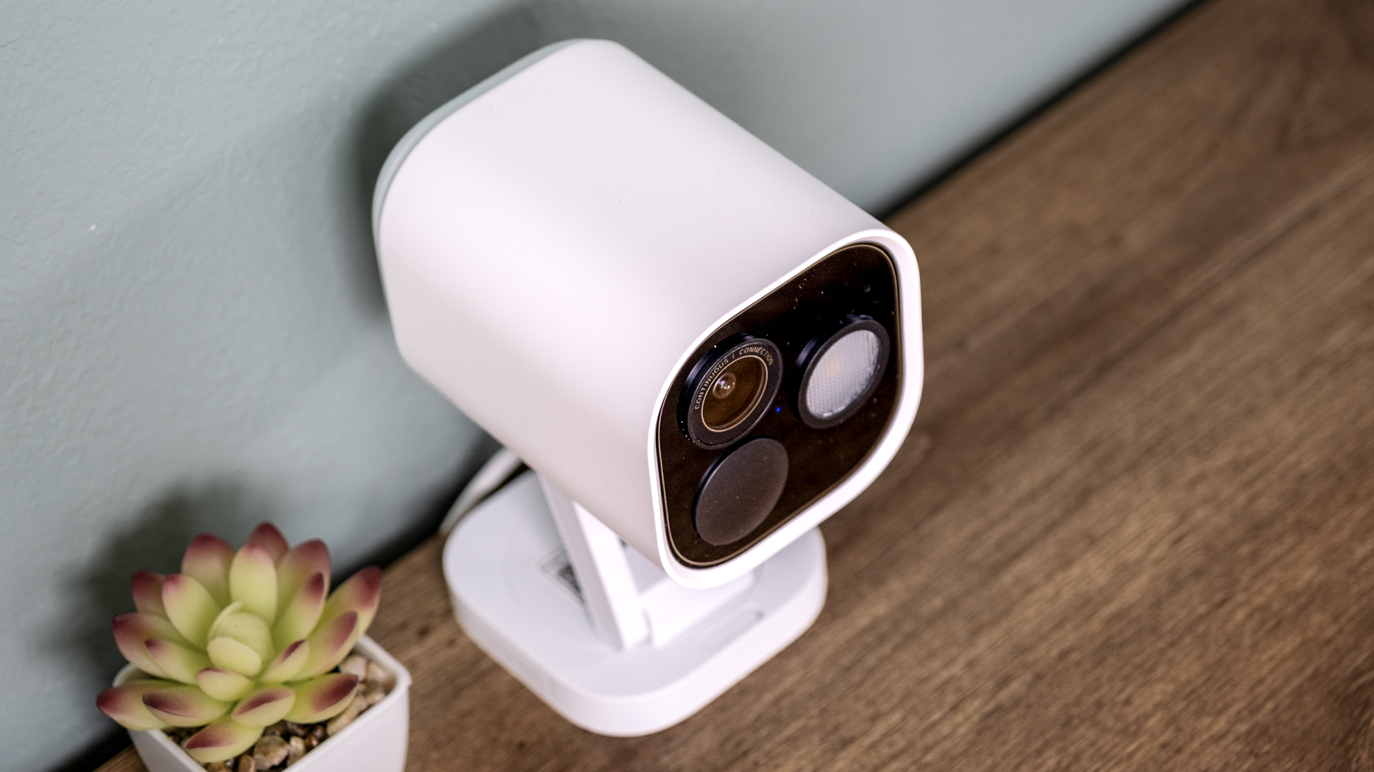 Aqara Camera Hub G5 Pro on a shelf with a small cactus.