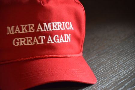 A Donald J. Trump Make America Great Again hat staged on a wooden table from the 2020 Presidential campaign in Indianapolis, Indiana