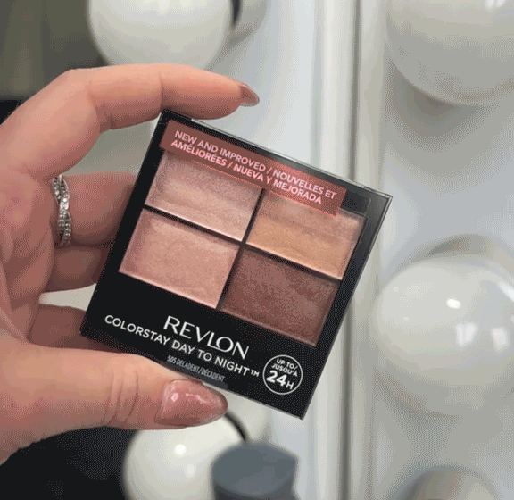 a close up video of a manicured hand holding a Revlon palette