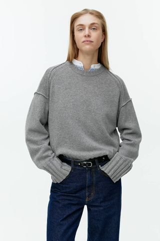 grey jumpers woman wearing oversized knit