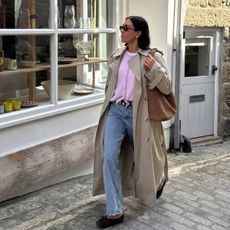 Jessica Skye wears lightweight spring knit cardigan with jeans and a trench coat.