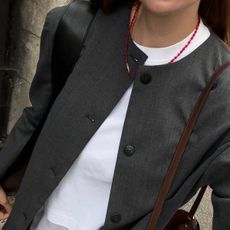 Woman in gray collarless blazer