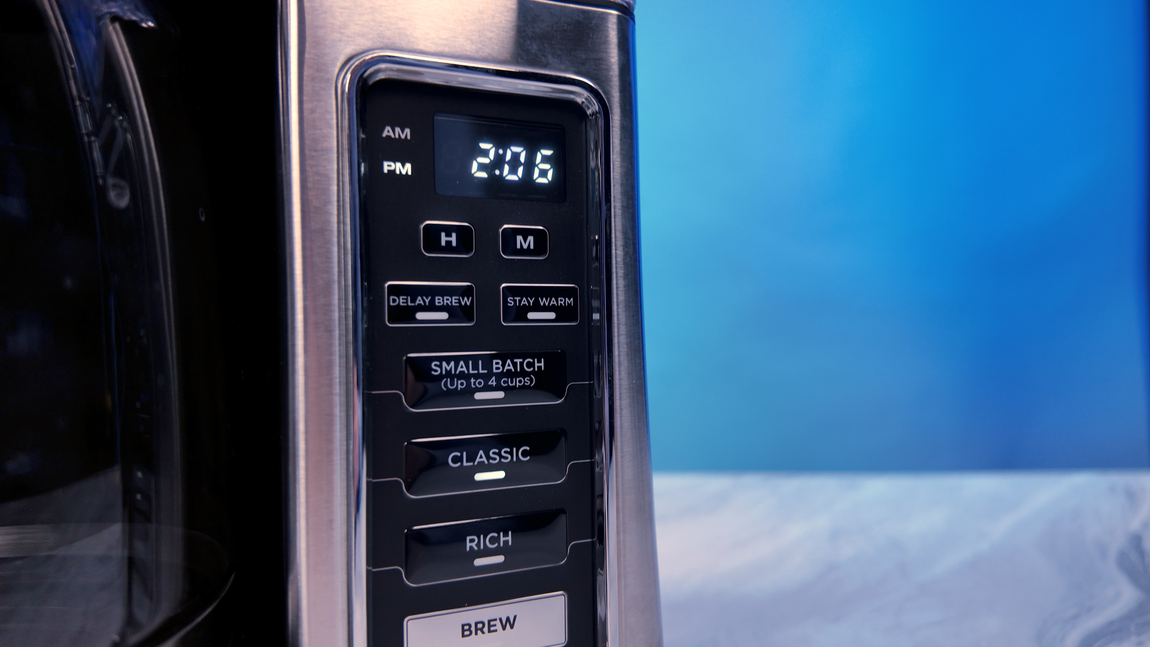 the ninja 12 cup brewer coffee maker with a blue background making coffee