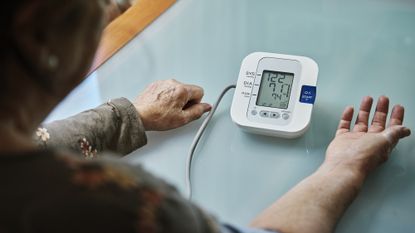 Woman measuring her blood pressure