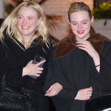 Elle and Dakota Fanning joined each other for a night out with different black It-bags