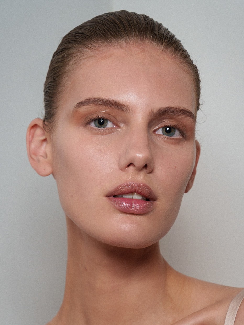 A model with clear skin and glossy eyeshadow