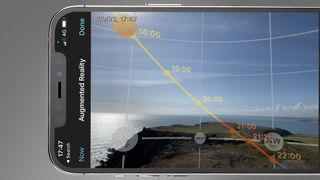 A phone screen showing the Photopills apps prediction of the sun's movement through the sky