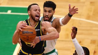 Stephen Curry #30 of the Golden State Warriors fights for position against Jaylen Brown #7 and Jayson Tatum #0 of the Boston Celtics