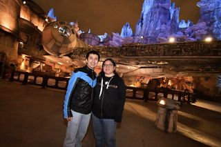 Christine and husband in front of Millennium Falcon at Star Wars Galaxy's Edge