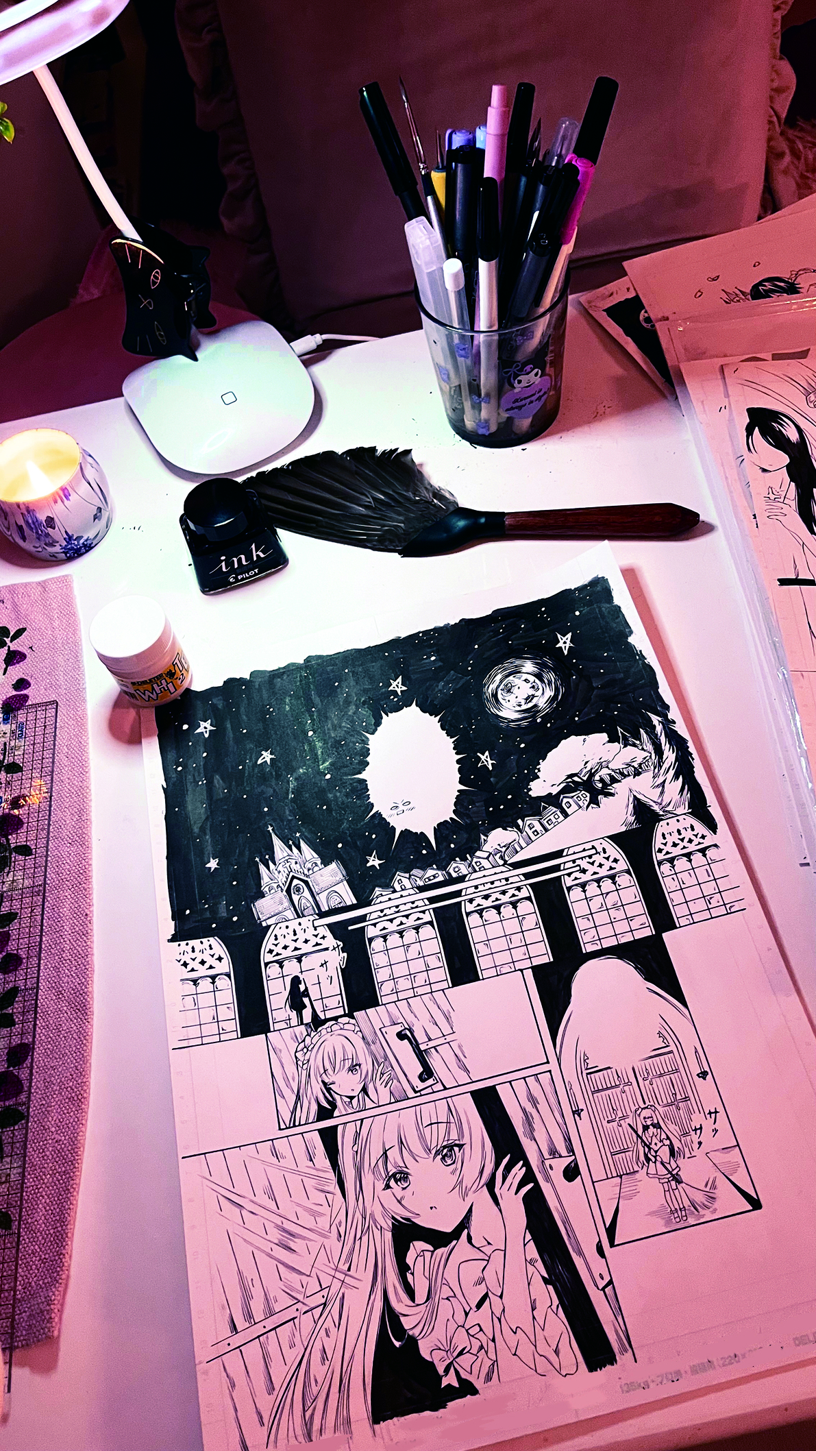 Artist's studio; anime panels, small feather duster and pens