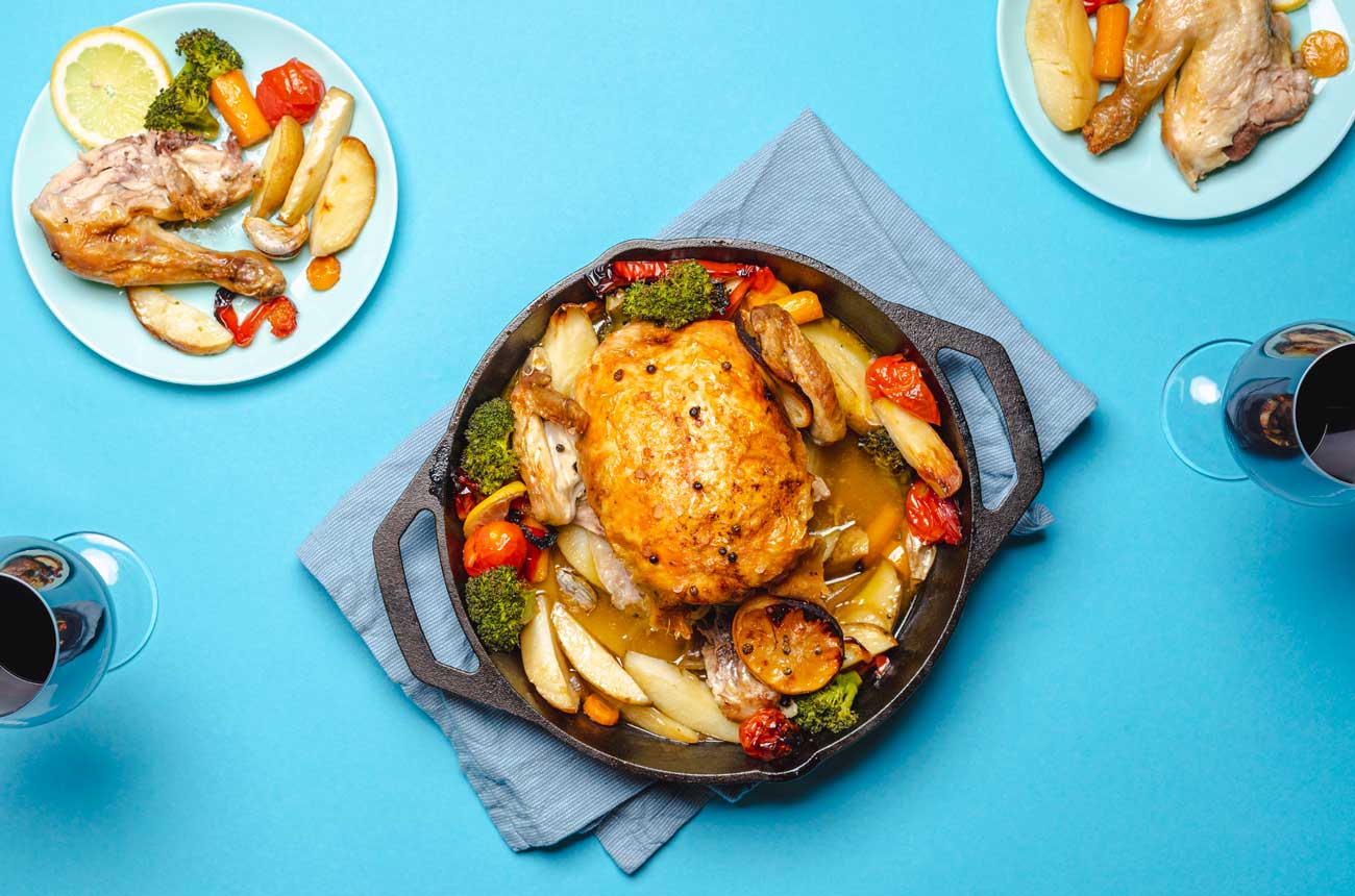 Roast chicken and wine glasses on a table