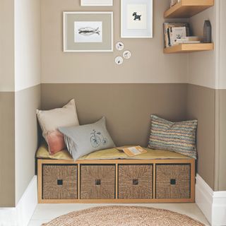 Rattan sideboard with four compartments, cushions on top and underneath wall prints and shelves