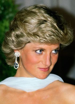 Diana, Princess of Wales at the Cannes Film Festival for a gala night in honour of actor Sir Alec Guinness, The Princess is wearing a pale blue silk chiffon strapless dress with a matching chiffon stole designed by fashion designer Catherine Walker