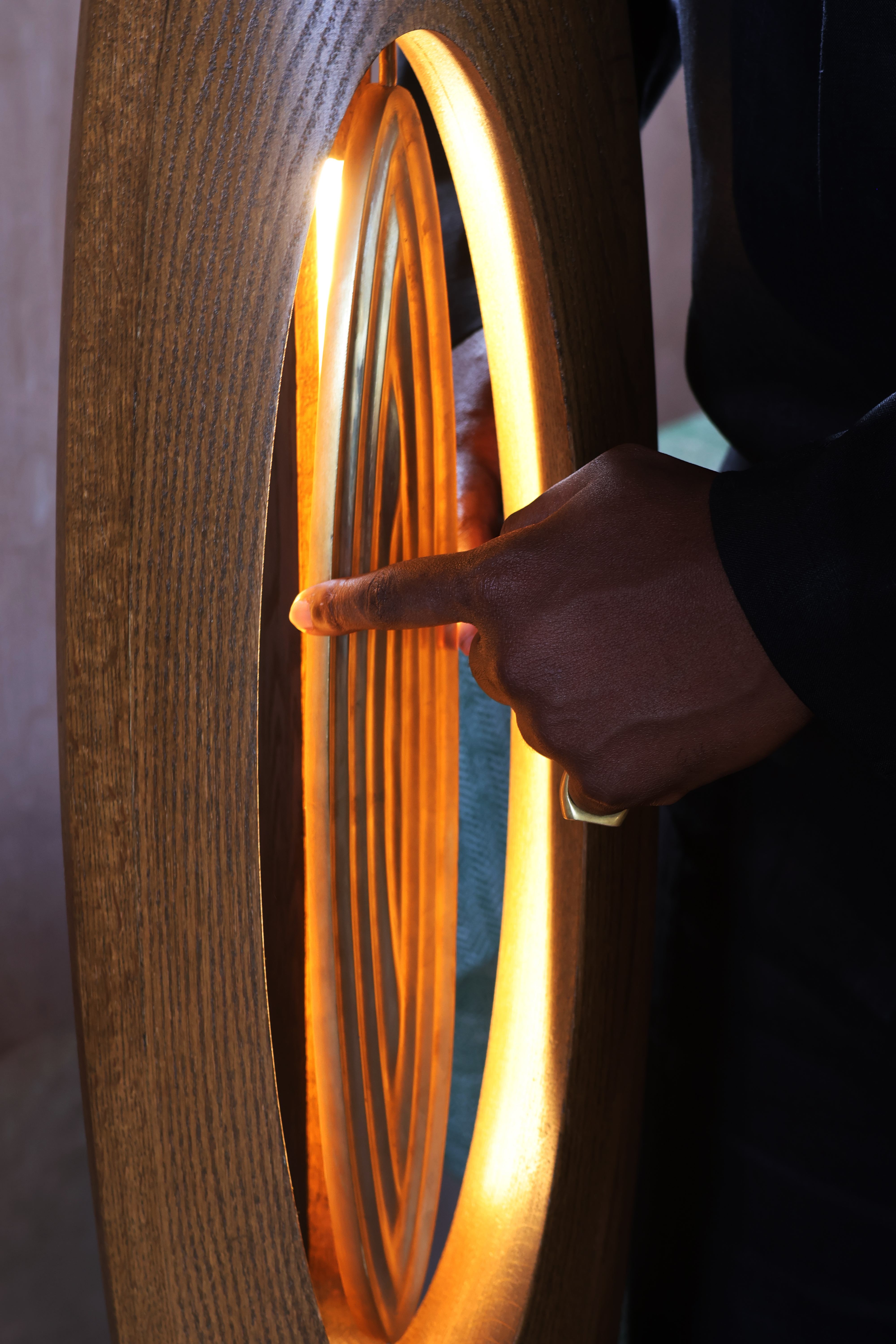 Male hand touching wooden light