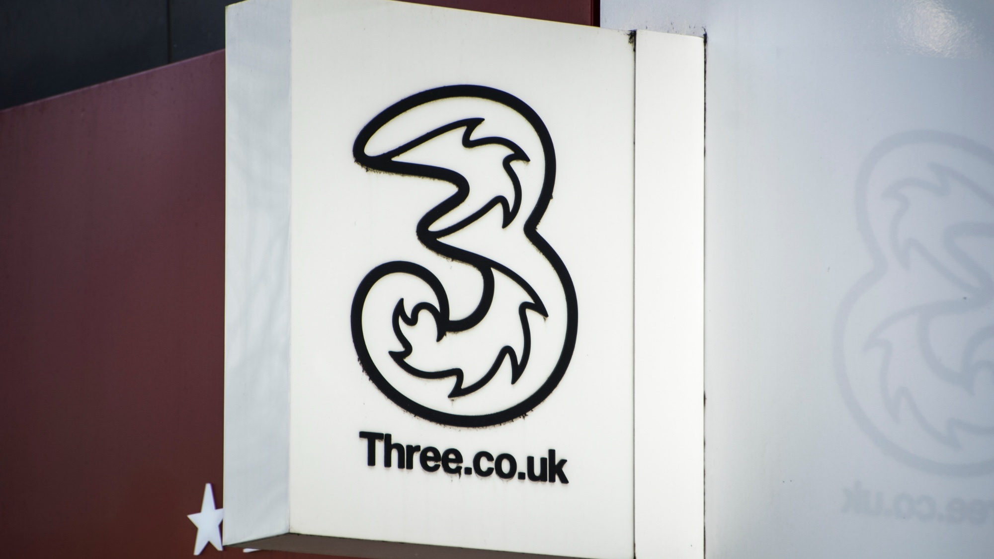 three uk store sign with logo