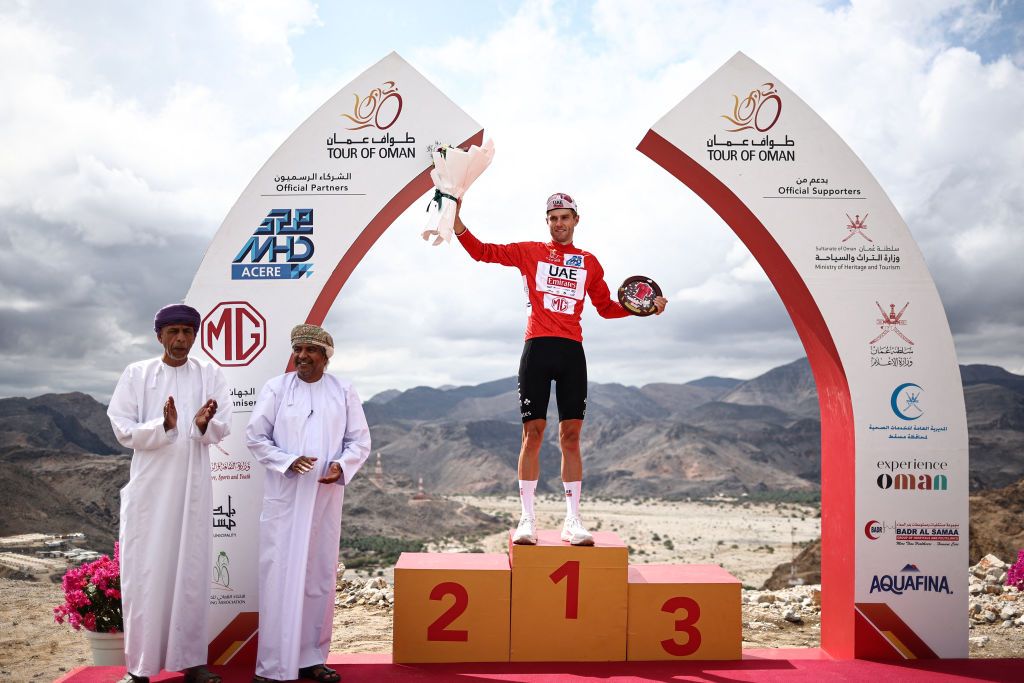 New Zealand&#039;s Finn Fisher-Black (UAE Team Emirates) holds flowers on the podium after taking the lead in the general classification during stage 4 of the Tour of Oman