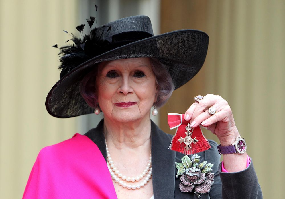 April Ashley, the first Briton to undergo sex-change surgery, poses with her Member of the British Empire (MBE) medal following an Investiture ceremony at Buckingham Palace in central London on December 13, 2012.