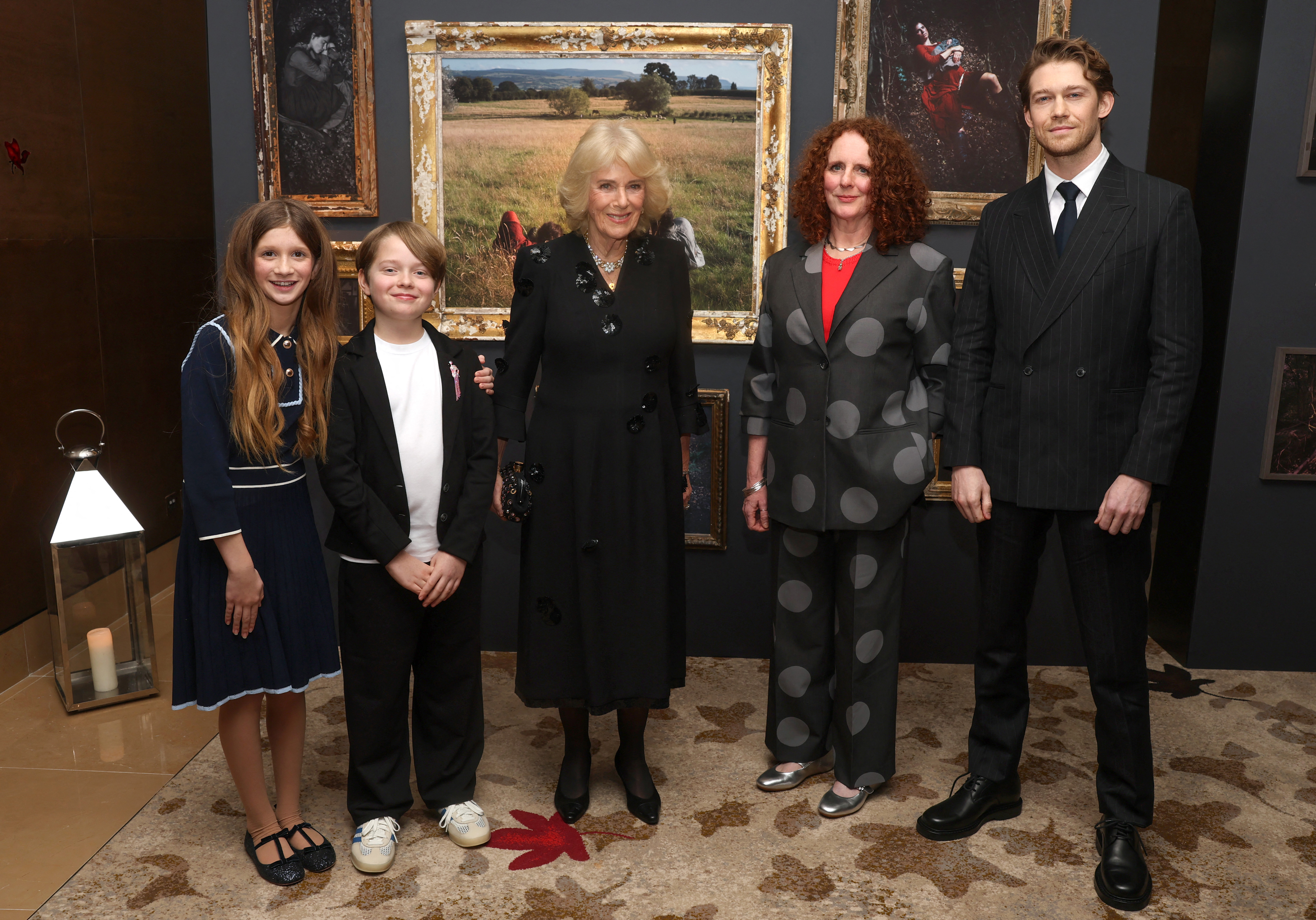 Britain's Queen Camilla (C) poses with actor Olivia Lynes (L), actor Jacobi Jupe (2L), author Maggie O'Farrell (2R) and actor Joe Alwyn ahead of a special screening of 'Hamnet'