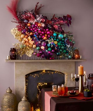 Maximalist fireplace styling with jewel coloured floral tapestry
