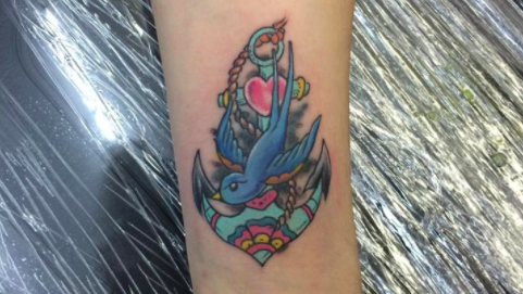 Anchor and bird tattoo