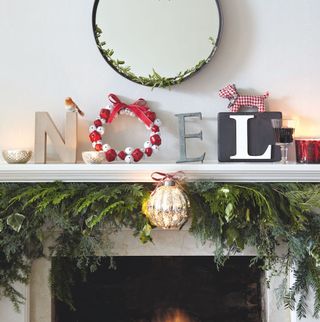 Noel lettering on mantel using a wreath as the O