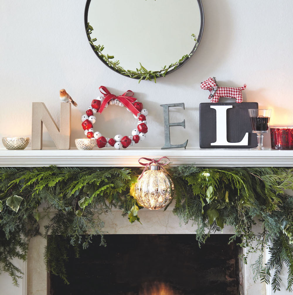 Noel lettering on mantel using a wreath as the O