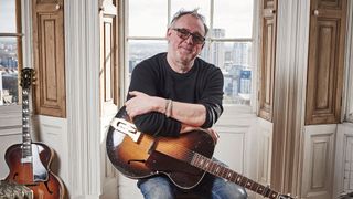 Adrian Utley of Portishead holding a 1936 Gibson L-4