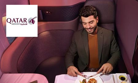 Qatar airways logo top left with a man eating in first class