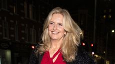 Penny Lancaster wearing a red blouse and black skirt